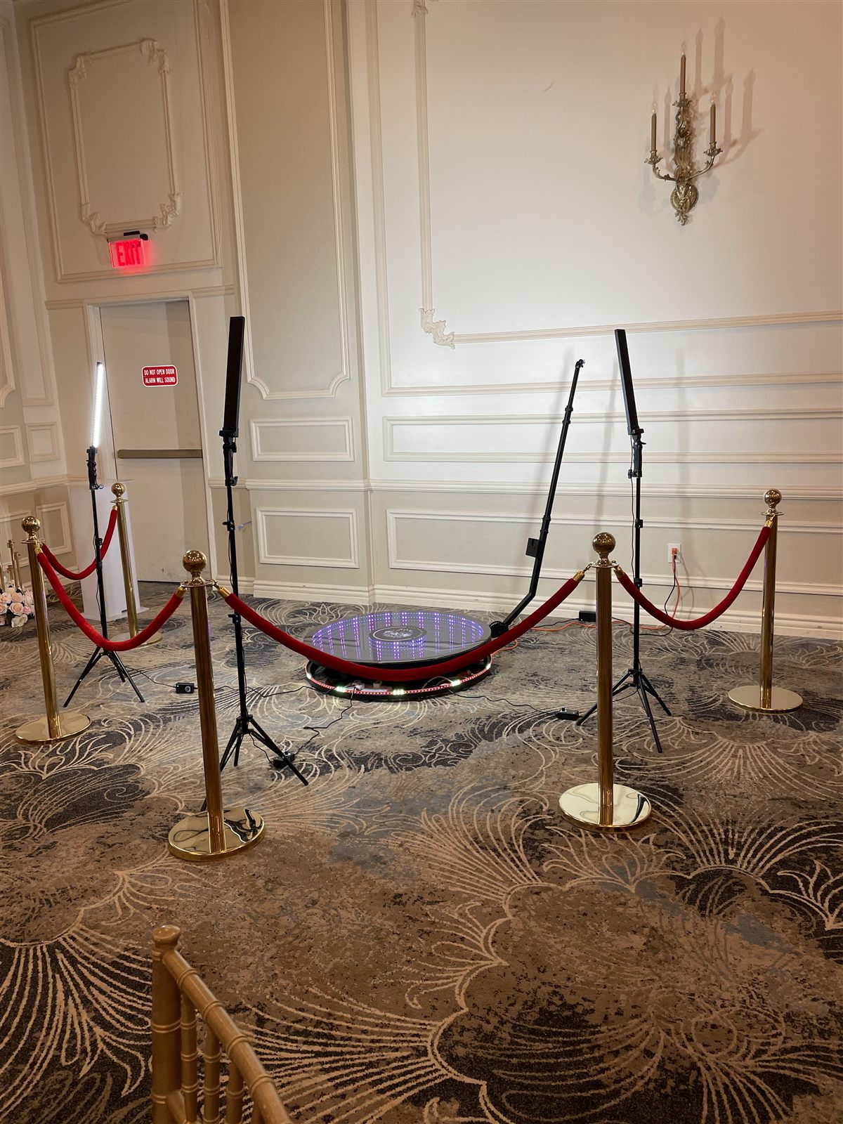 360 Party Wheel spin booth roped off with red carpet in a ballroom