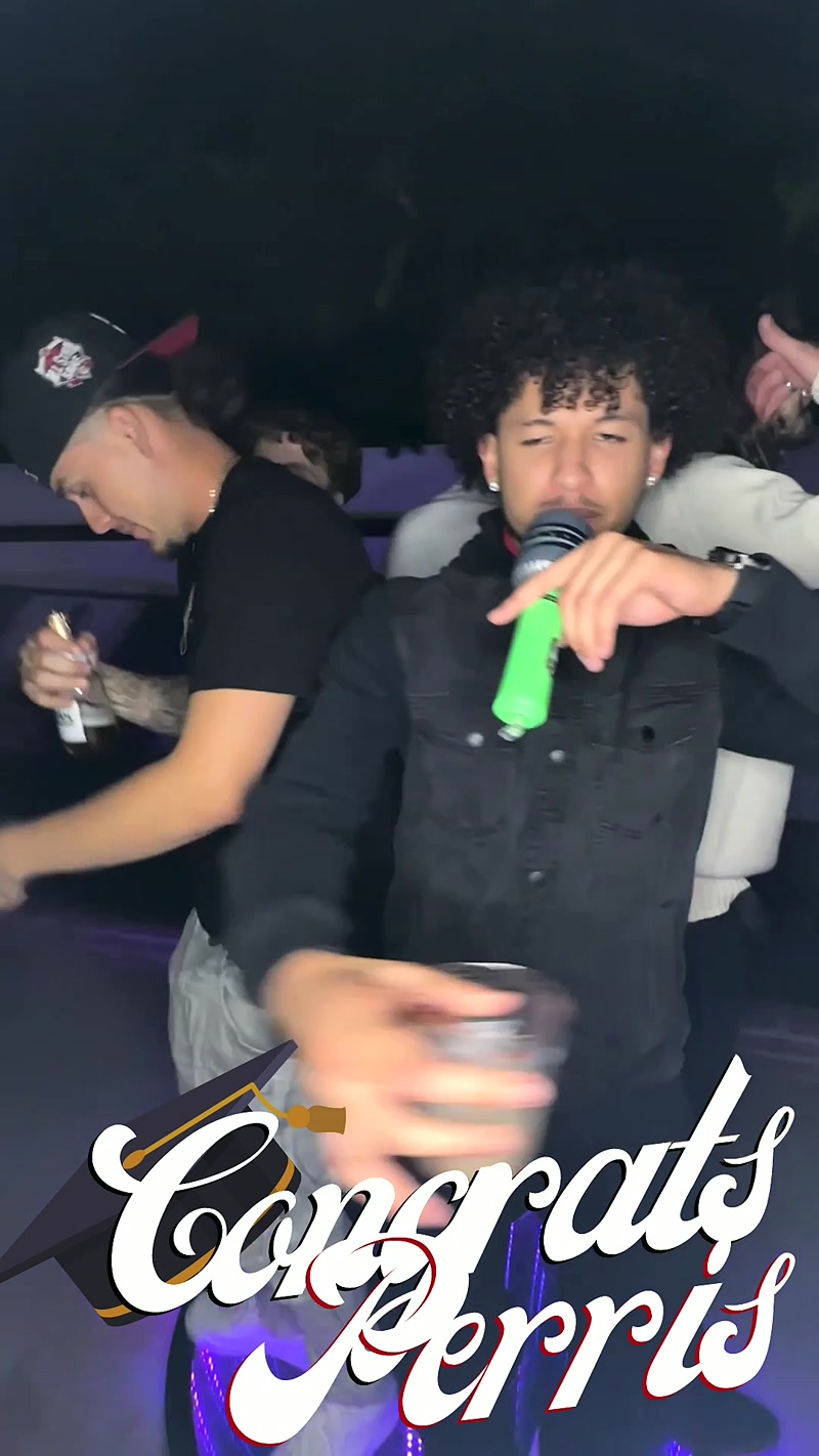 Party guest singing into a green microphone at a graduation party