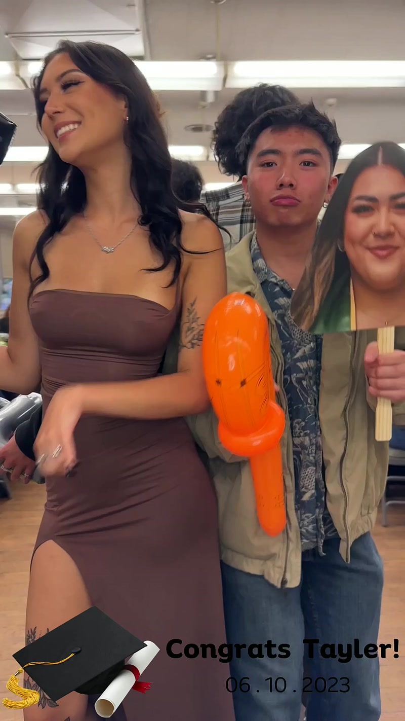 Graduation party guests posing with a cutout face prop